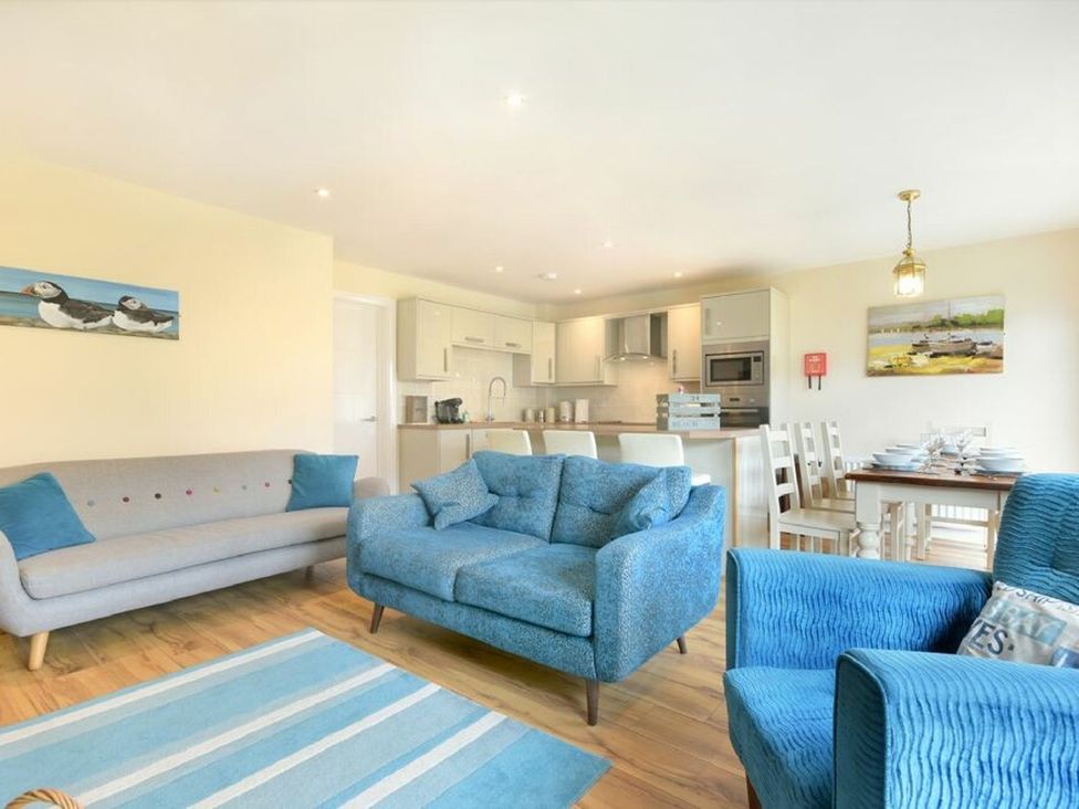 A living room with seating and dining area at Beach Walk in Chathill
