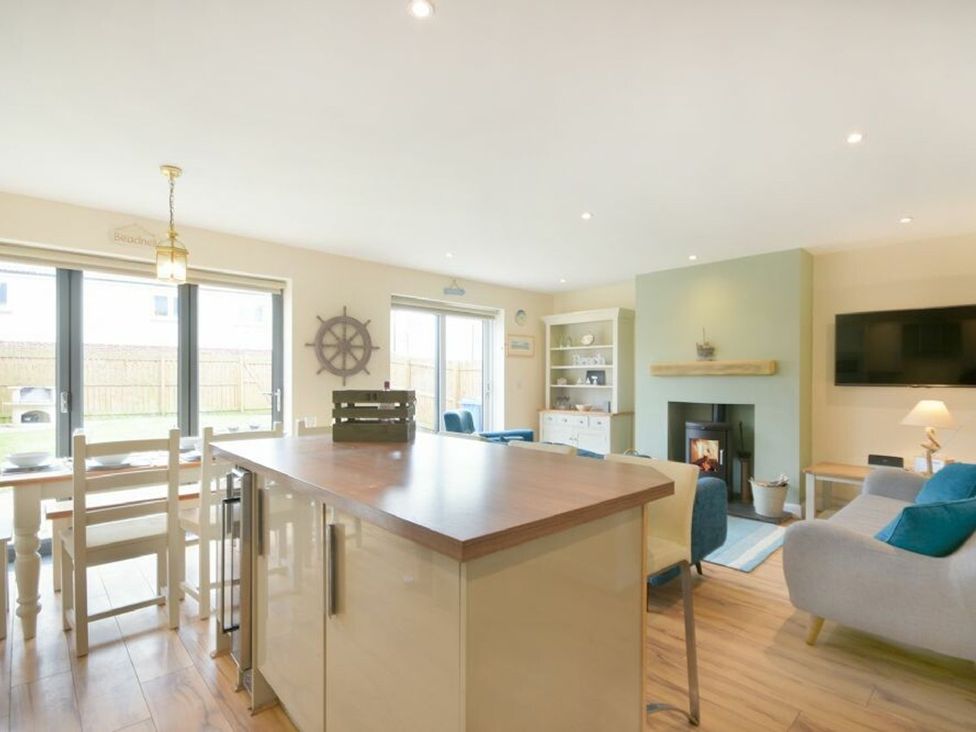 A living room with a table and chairs at Beach Walk in Chathill
