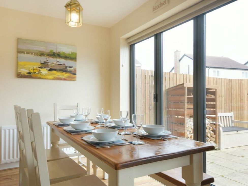 A dining room with a table set for dinner at Beach Walk in Chathill