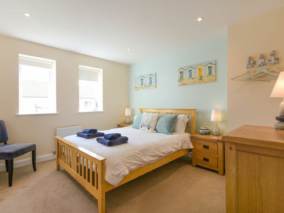 A bedroom with a bed and lamps at Beach Walk in Chathill