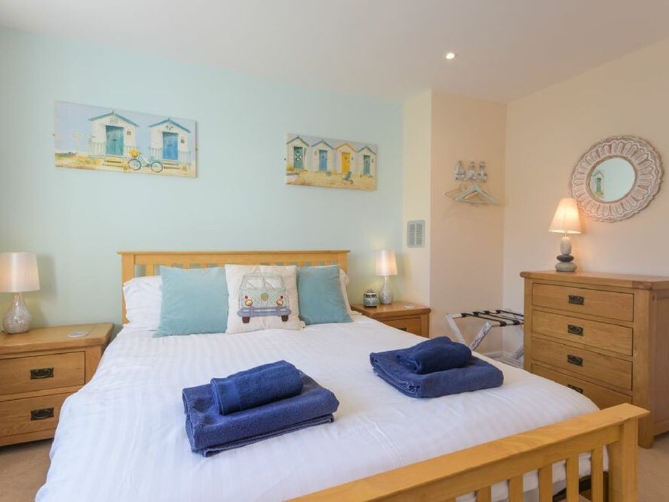 A bedroom with a bed and nightstand at Beach Walk in Chathill