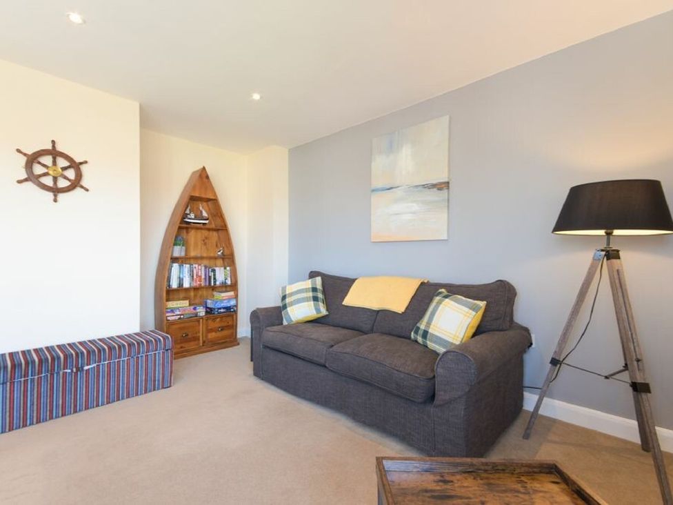 A living room with a shelf and a sofa at Beach Walk in Chathill
