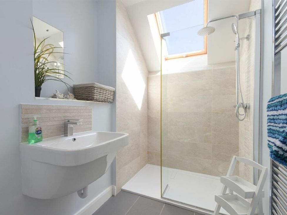 A bathroom with a sink and shower at Beach Walk in Chathill