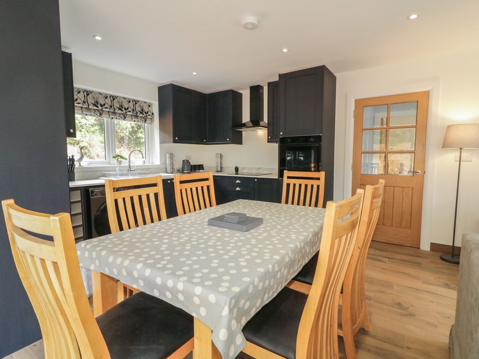 A kitchen with a dining table and chairs at Brook Cottage in Coleraine