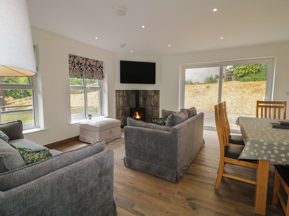 A living room with a sofa and fireplace at Brook Cottage in Coleraine