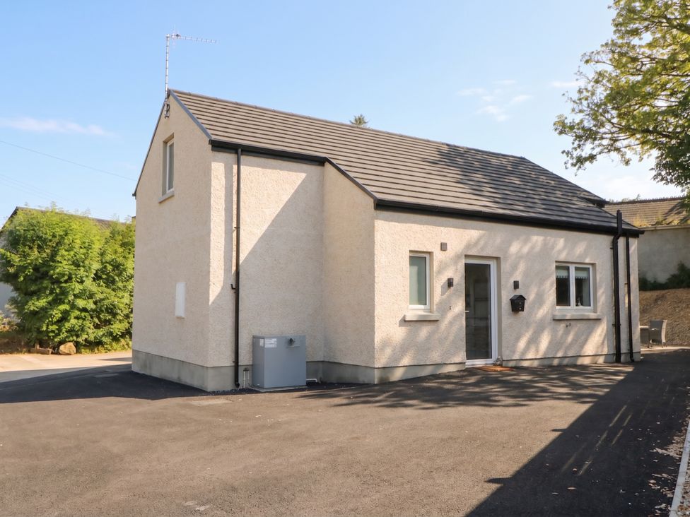 A house with windows and a driveway at Brook Cottage near Coleraine