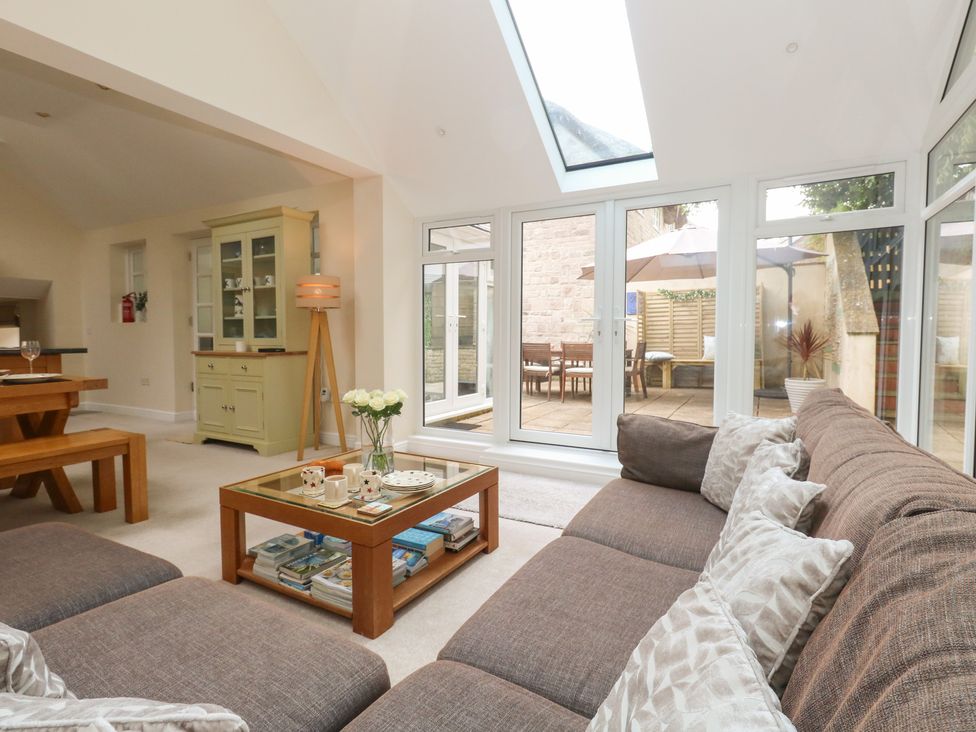 A living room with a sofa and coffee table at Woodbine Cottage in Weymouth