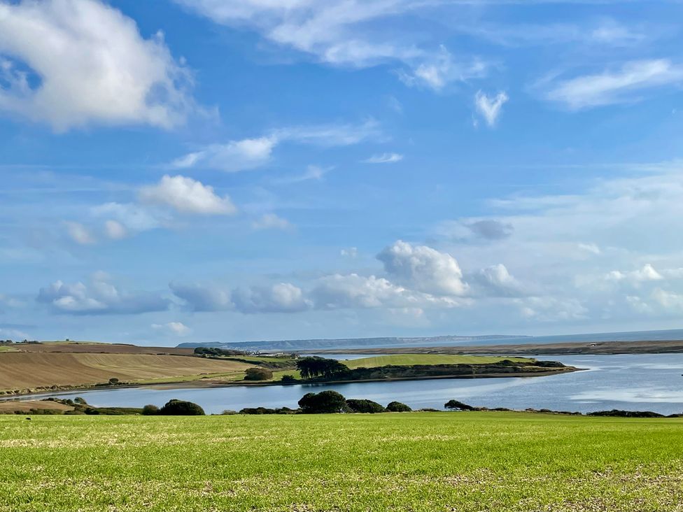 A view of hills and water at Woodbine Cottage in Osmington