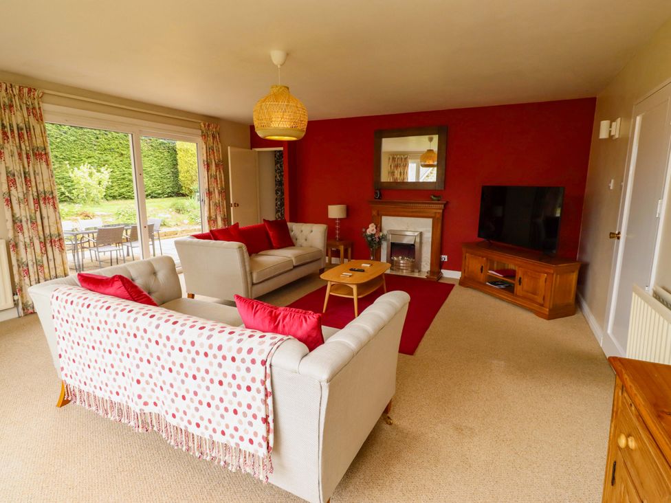 A living room with a sofa and television at Campden in Rennington near Embleton