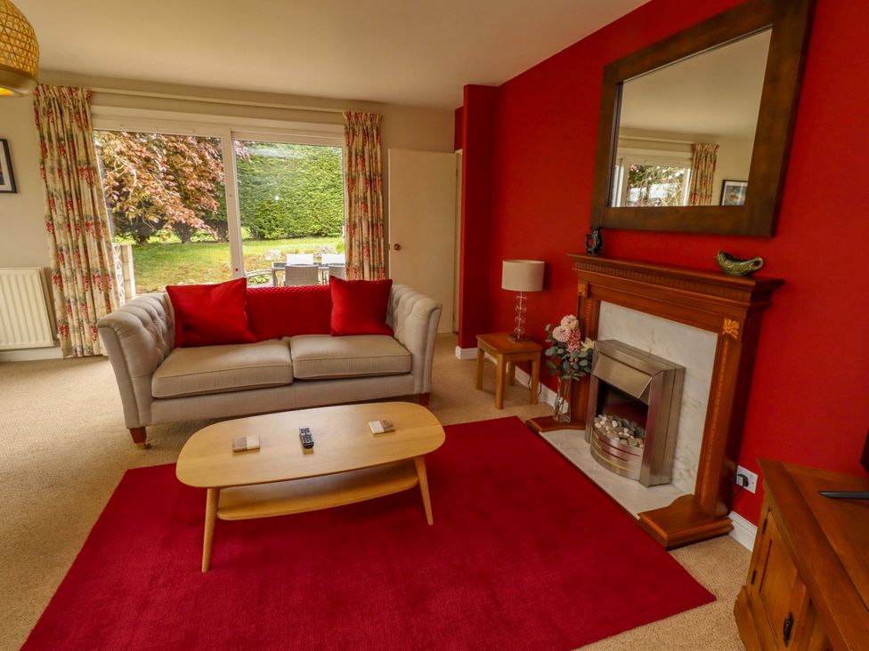A living room with a sofa and coffee table at Campden in Rennington near Embleton