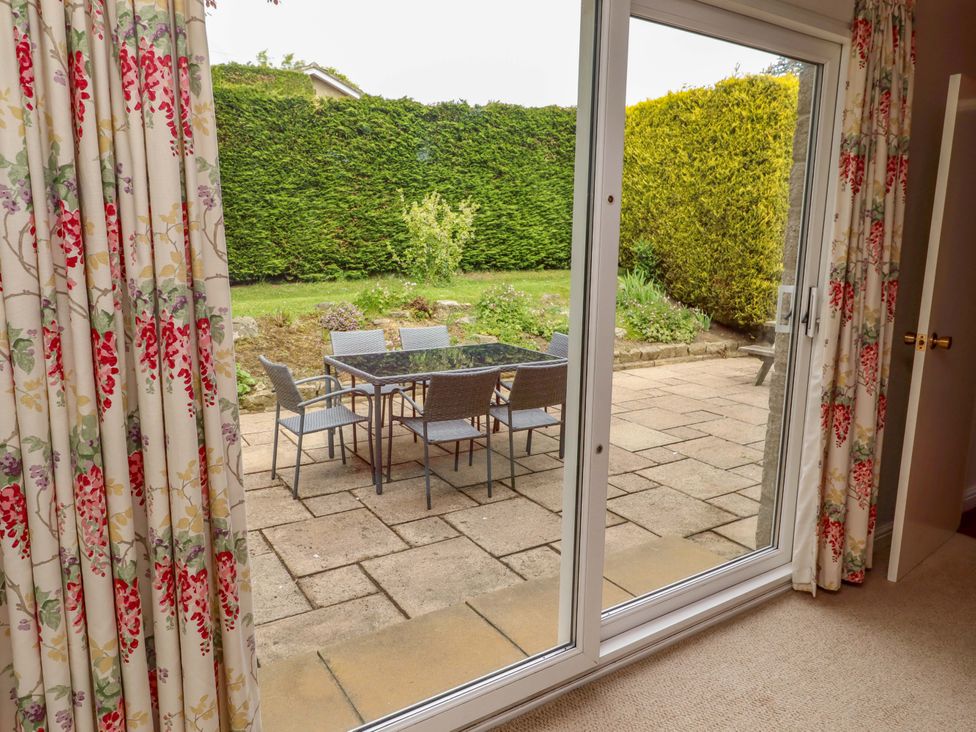 View of a patio with table and chairs from an indoor area at Campden in Rennington near Embleton