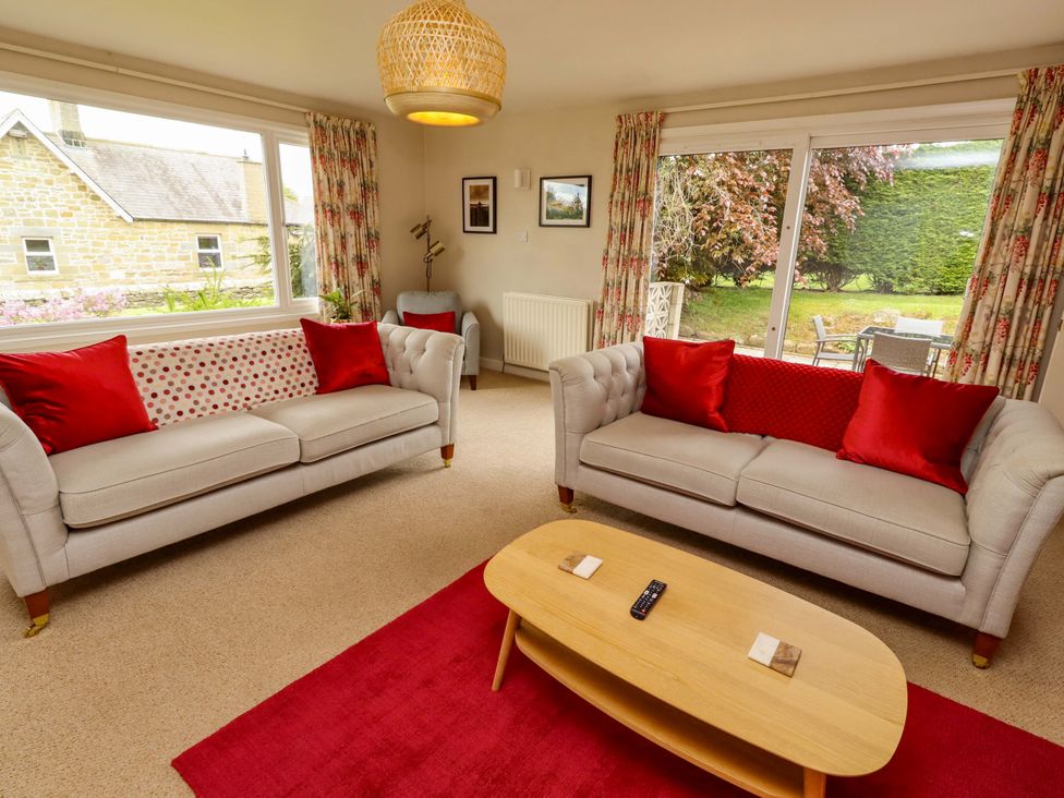 A living room with sofas and a coffee table at Campden in Rennington near Embleton