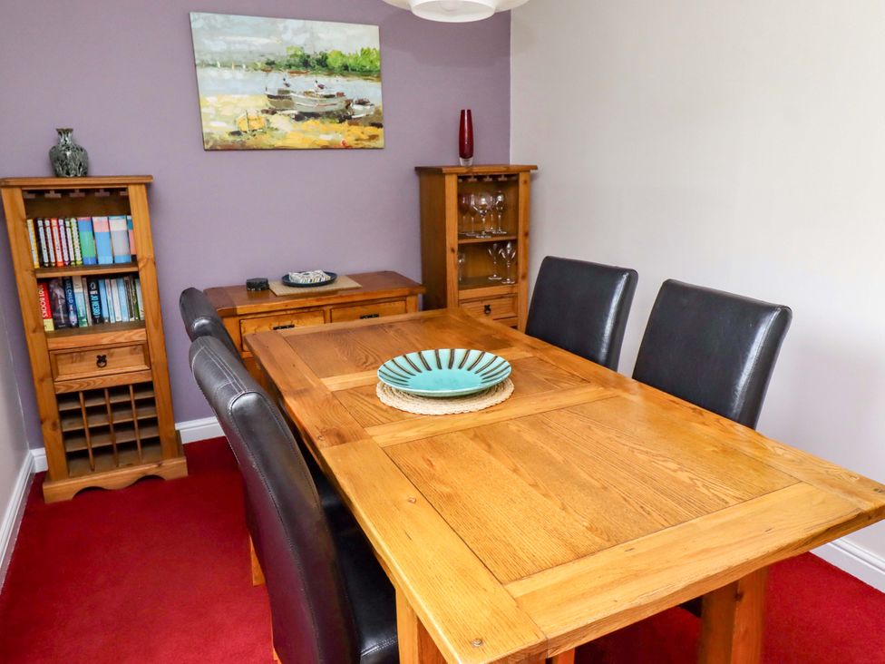 A dining room with a wooden table and chairs at Campden in Rennington near Embleton