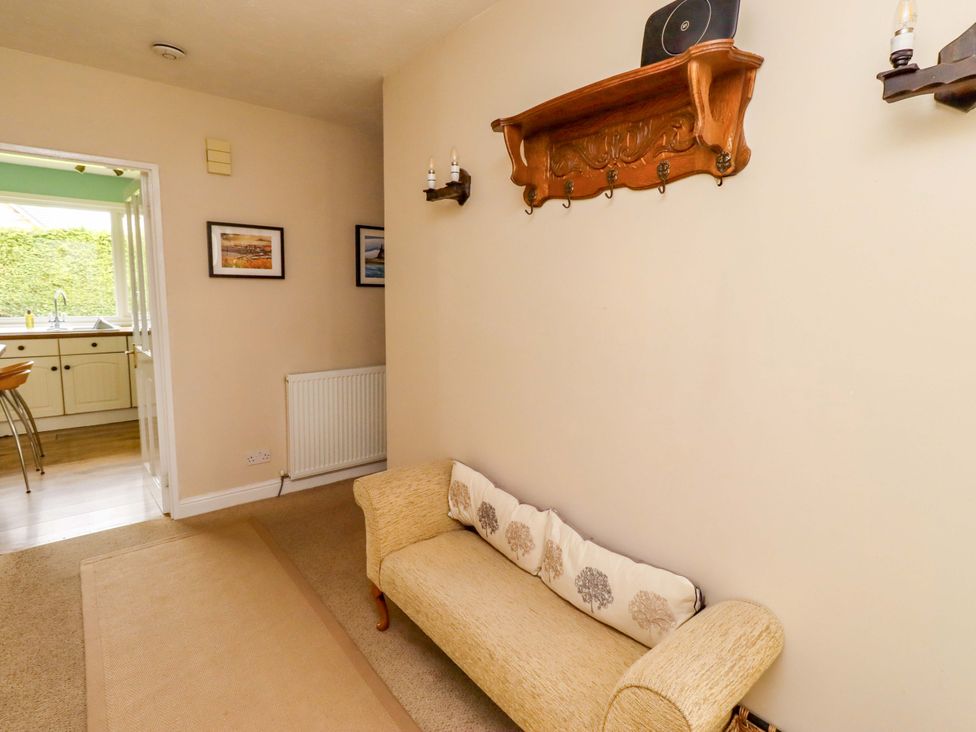 A hallway with a sofa and framed pictures at Campden in Rennington near Embleton