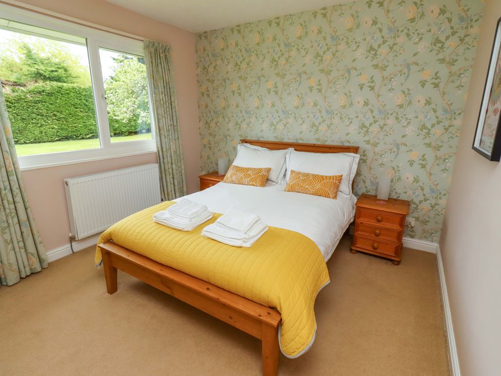A bedroom with a bed and bedside table at Campden in Rennington near Embleton