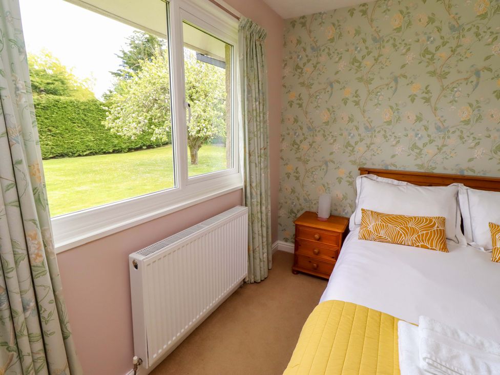 A bedroom with a bed and bedside table at Campden in Rennington near Embleton