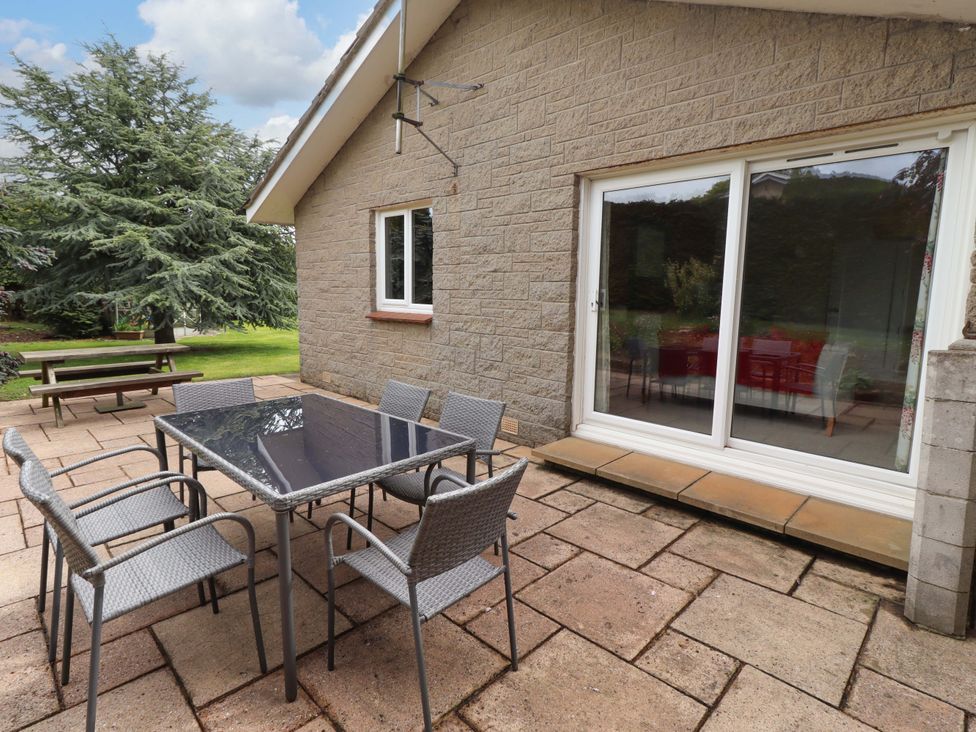 A patio with a table and chairs at Campden in Rennington near Embleton