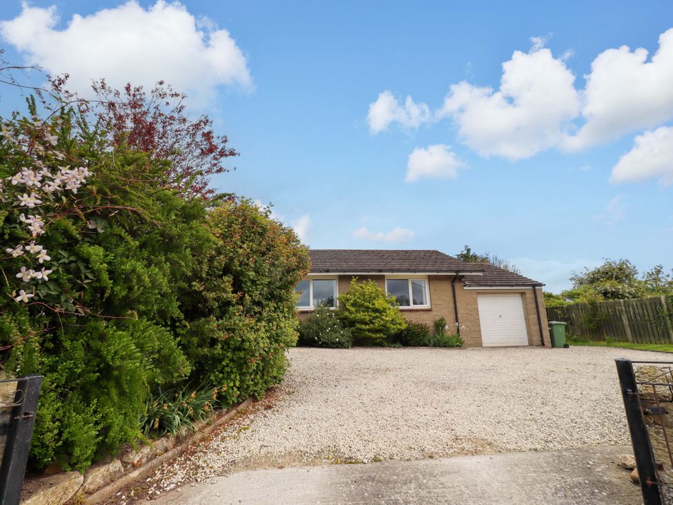 A house with a garage and driveway at Campden in Rennington near Embleton