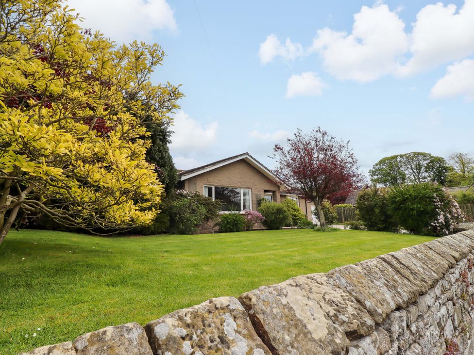 An exterior view of a house surrounded by a garden at Campden in Rennington near Embleton