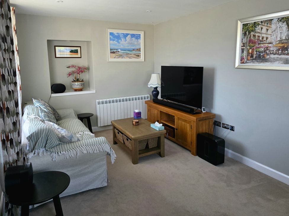 A living room with a sofa and television at Pant in Holyhead