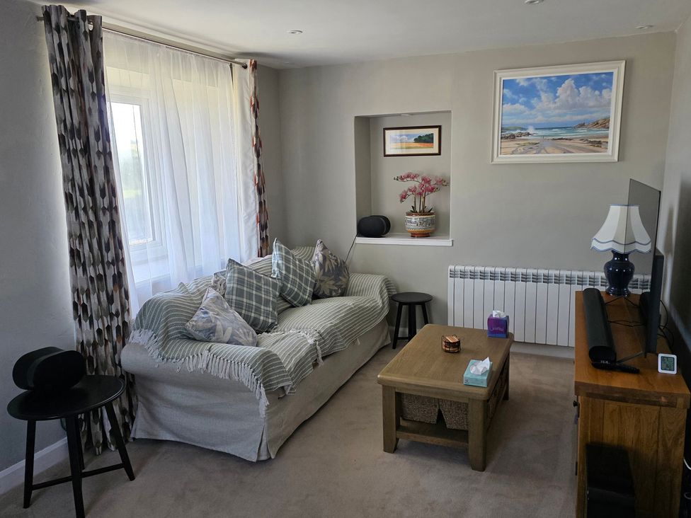 A living room with a couch and table at Pant in Holyhead