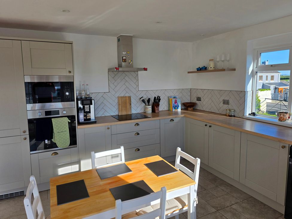A kitchen with a table and chairs at Pant in Holyhead