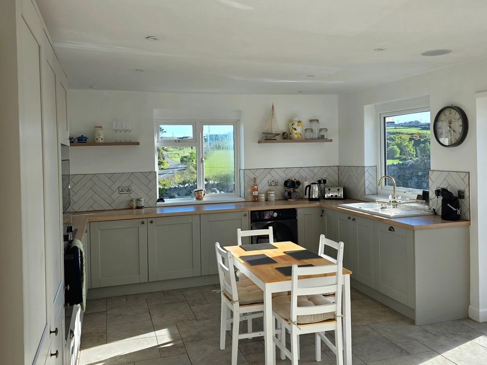 A kitchen with a table and chairs at Pant in Holyhead