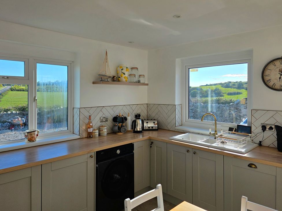A kitchen with windows and appliances at Pant in Holyhead