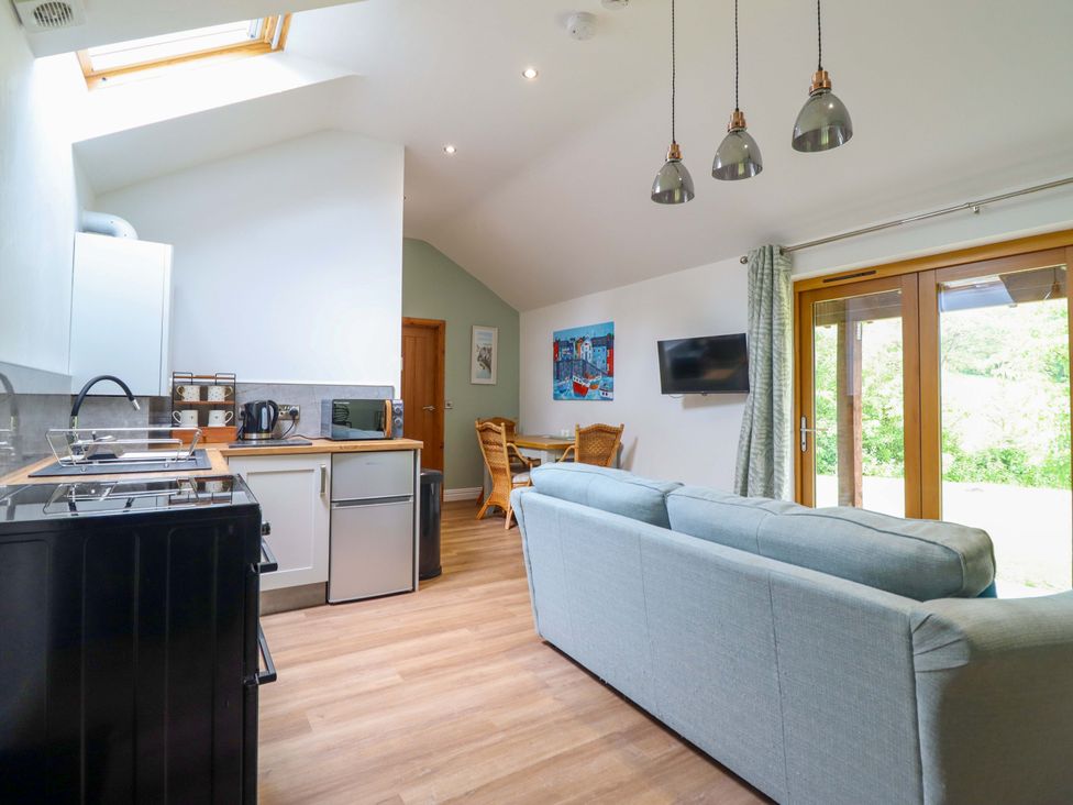 A kitchen with a dining area and sofa at Henlle Home Farm in Gobowen