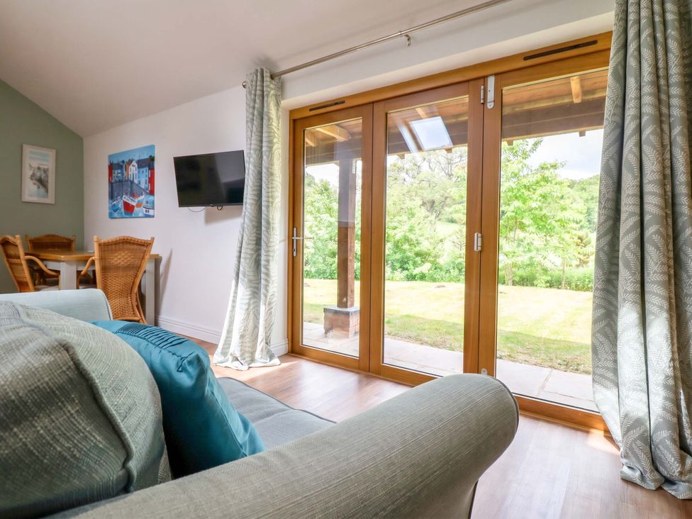 A living room with a sofa and television at Henlle Home Farm in Gobowen