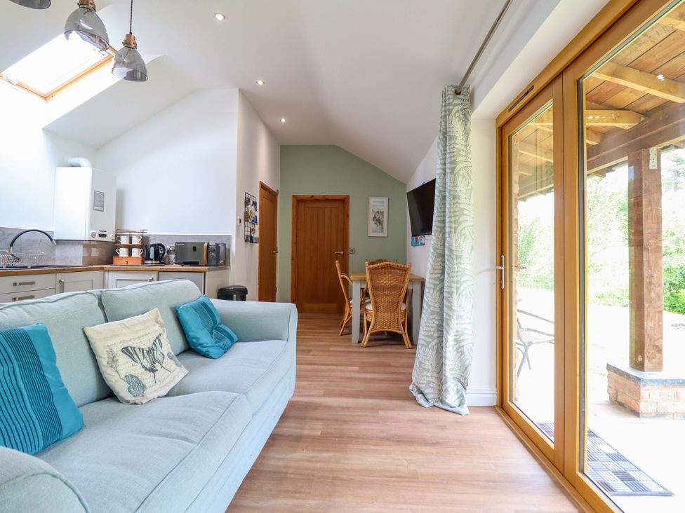 A kitchen with a sofa and dining area at Henlle Home Farm in Gobowen