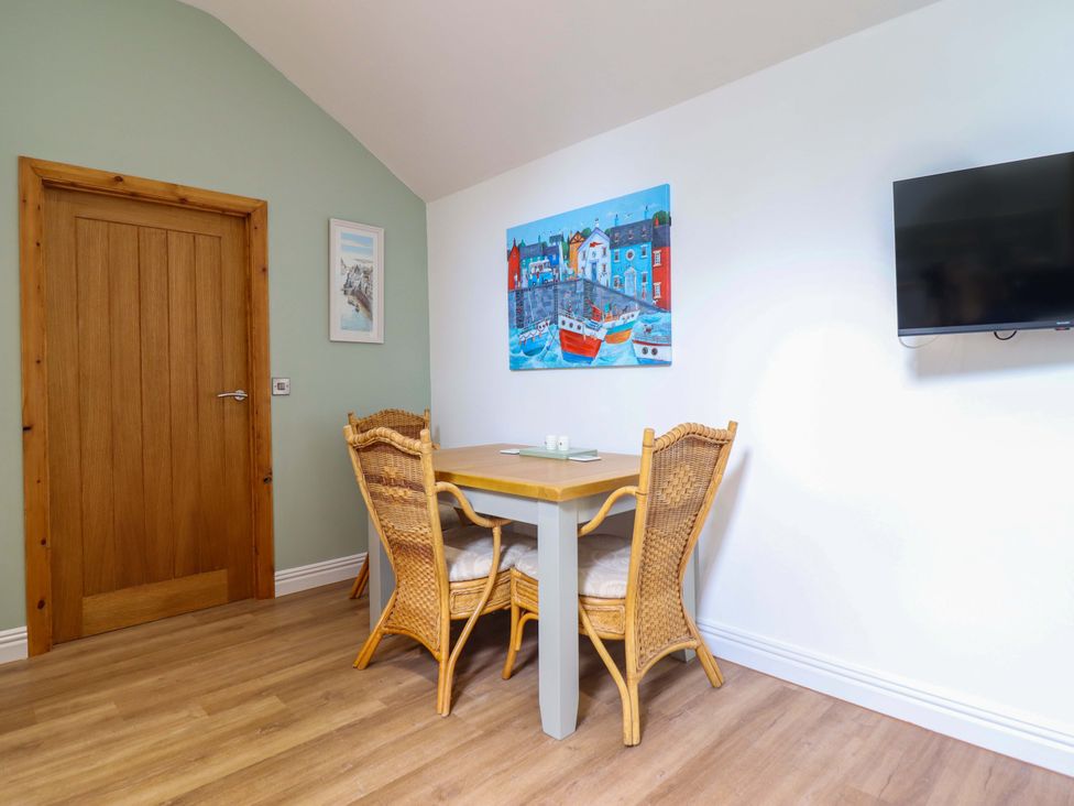 A dining room with a table and chairs at Henlle Home Farm in Gobowen