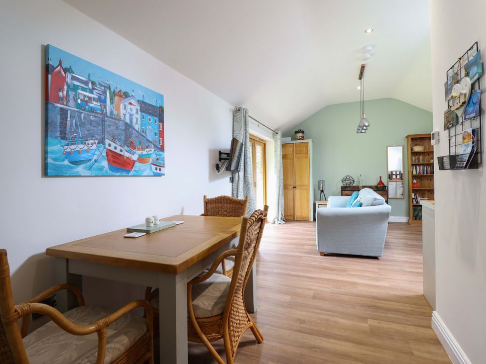 A dining room with a table and chairs at Henlle Home Farm in Gobowen