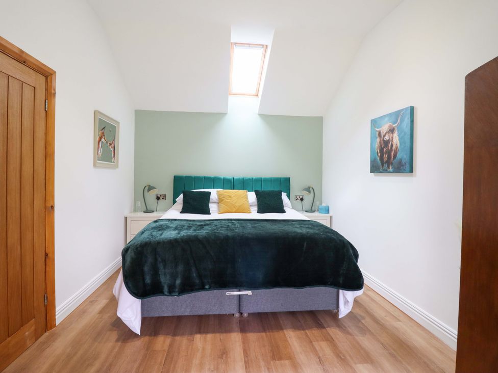A bedroom with a bed and nightstand at Henlle Home Farm in Gobowen