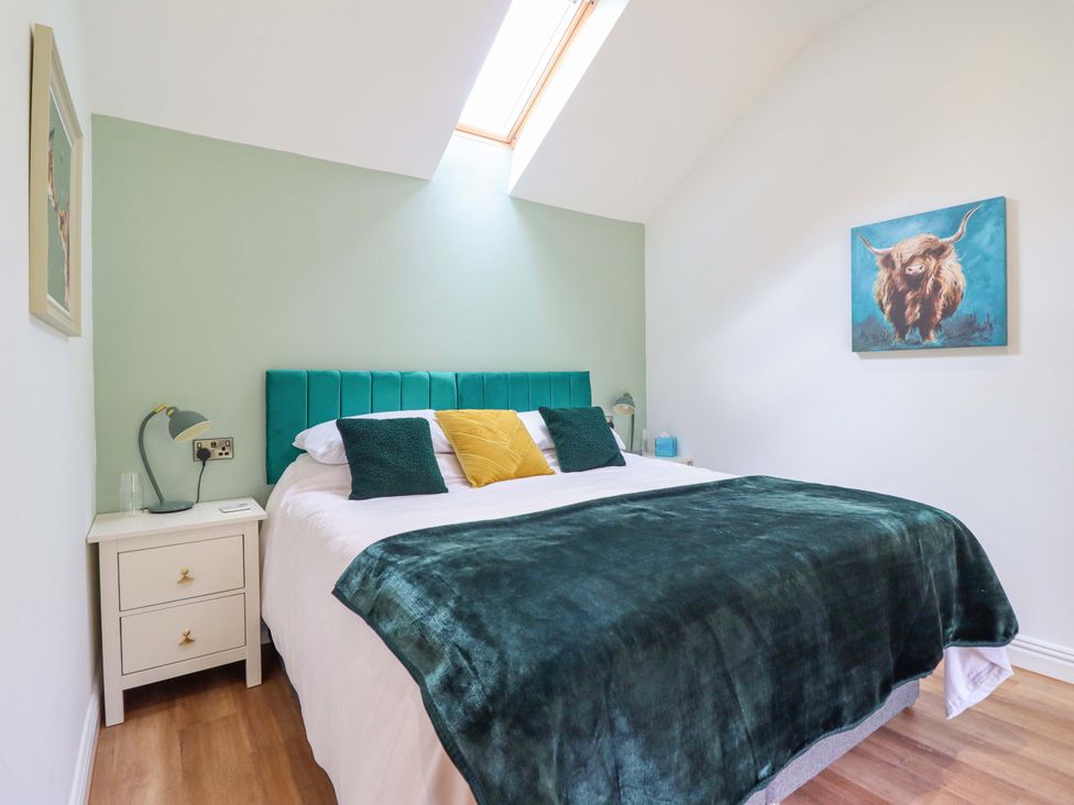 A bedroom with a bed and bedside table at Henlle Home Farm in Gobowen
