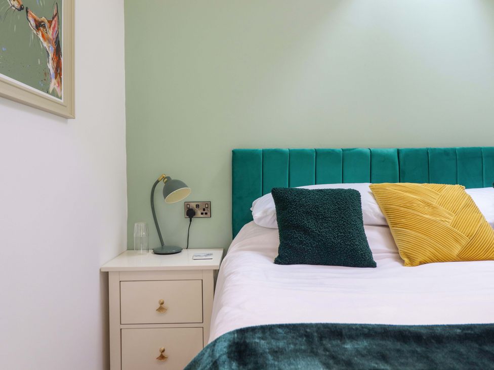A bedroom with a bed and bedside table at Henlle Home Farm in Gobowen