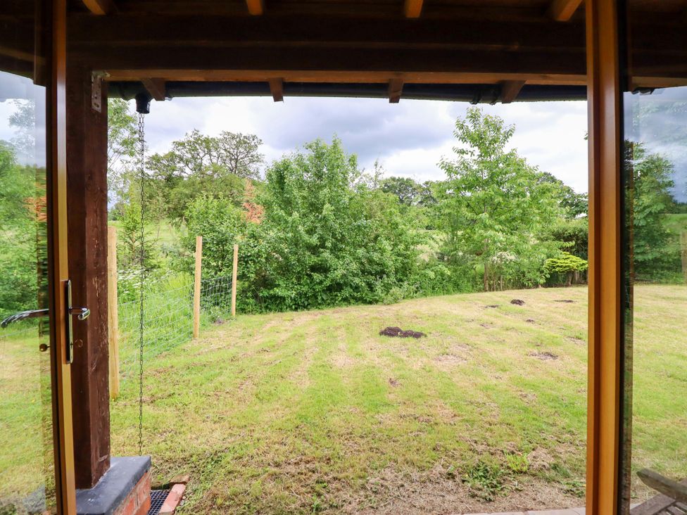 A garden view with grass and trees at Henlle Home Farm in Gobowen
