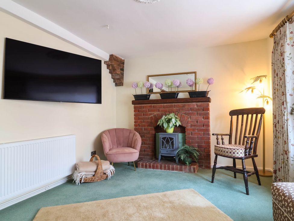 A living room with a television and fireplace at Pete's Place in Taunton