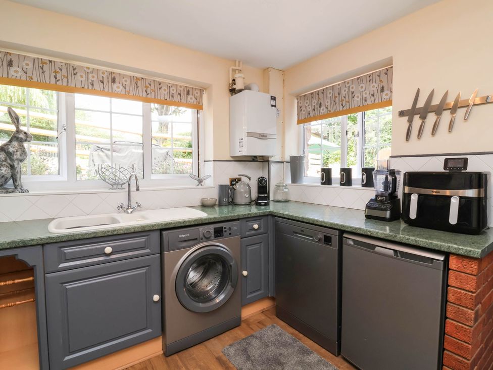 A kitchen with appliances and windows at Pete's Place in Taunton