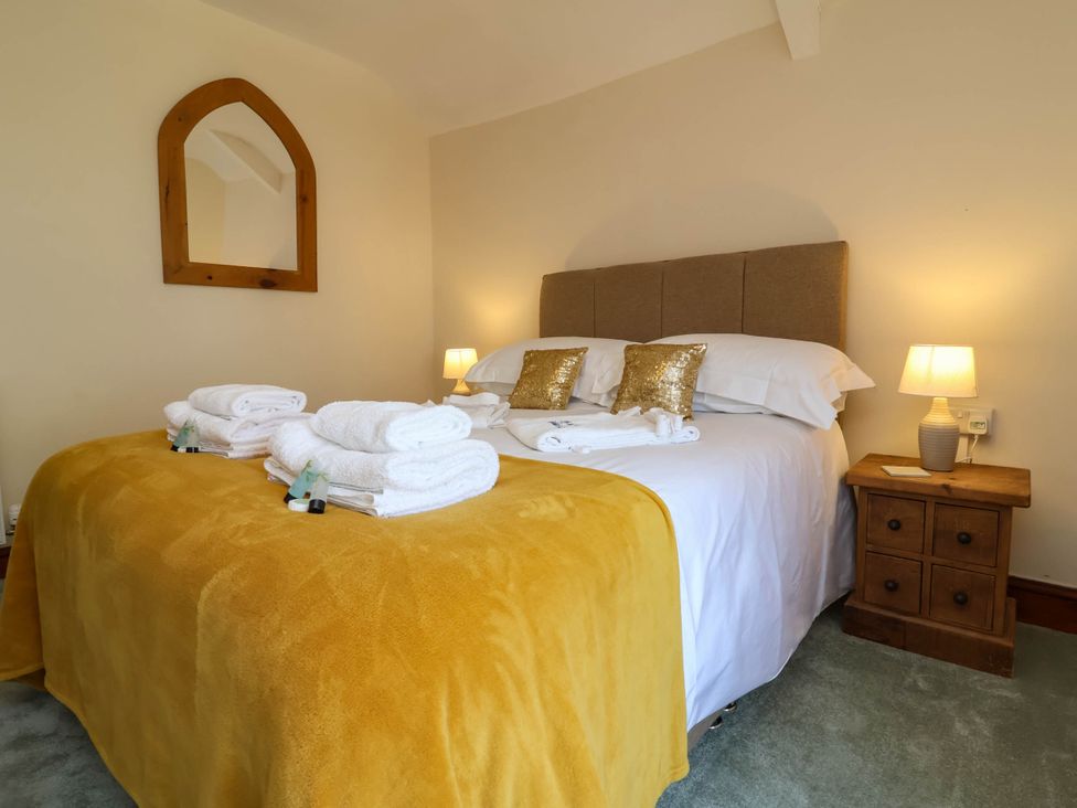A bedroom with a bed and nightstand at Pete's Place in Taunton