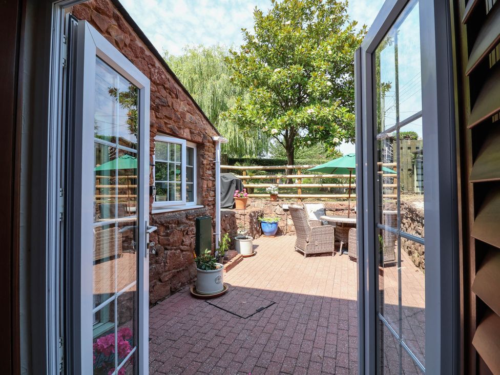 An outdoor patio area with a table and chairs at Pete's Place in Taunton