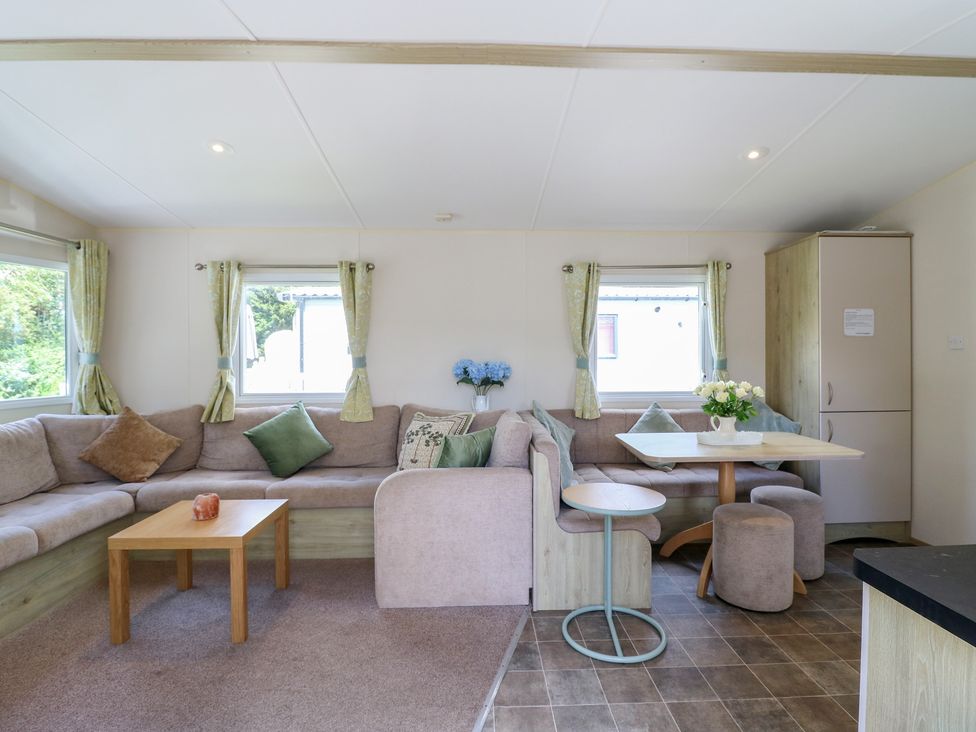 A living room with a sofa and table at Forest Retreat - FO26, Saxmundham