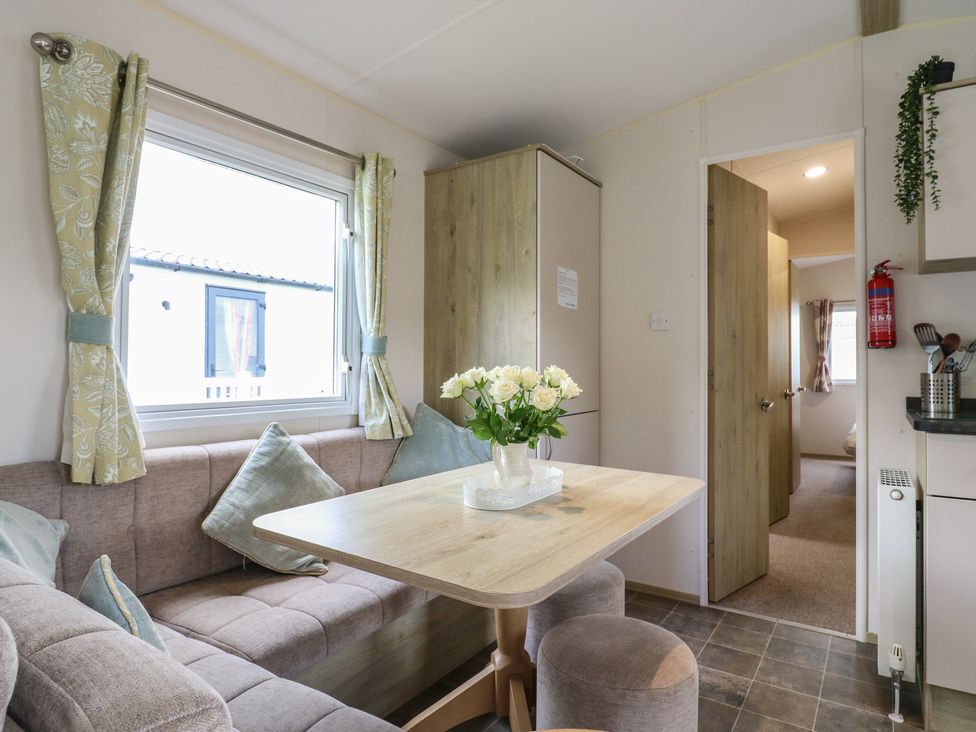A dining area with a table and chairs at Forest Retreat - FO26 in Saxmundham