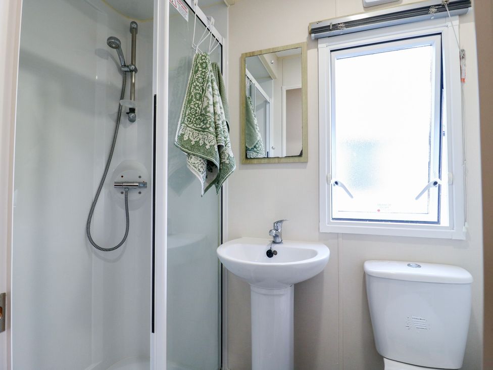 A bathroom with a shower, sink, and toilet at Forest Retreat - FO26 in Saxmundham