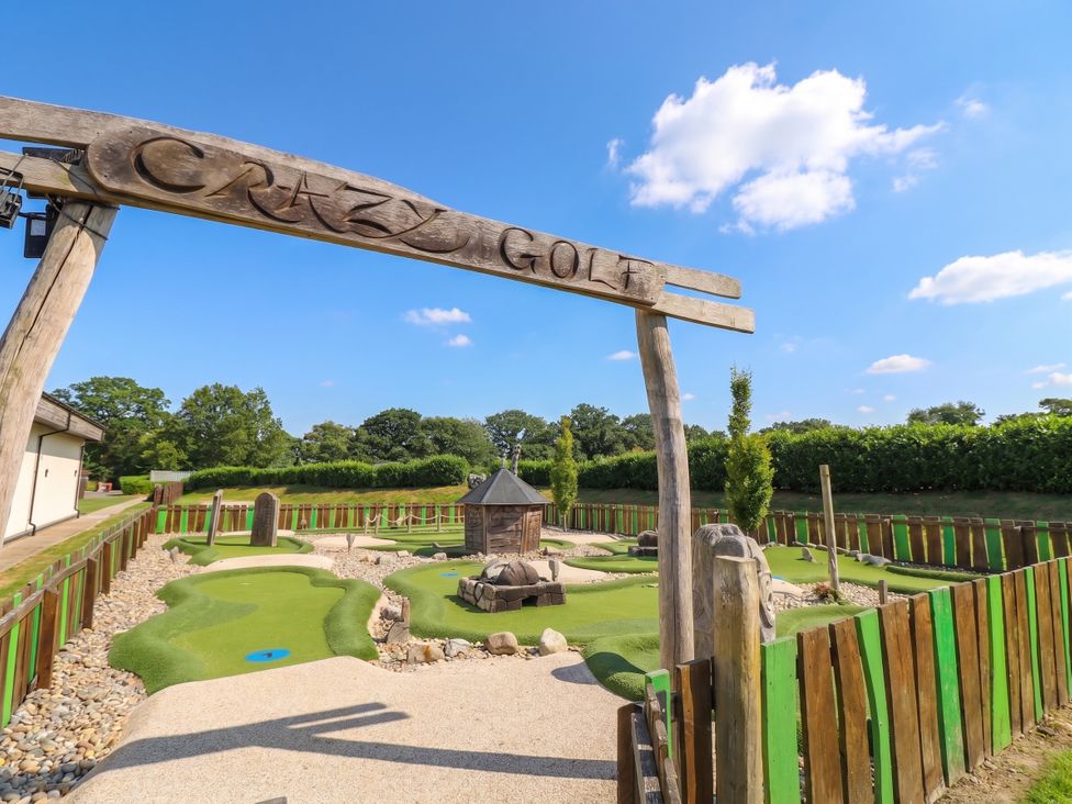 A crazy golf course with a sign in an outdoor setting at Forest Retreat - FO26 in Saxmundham