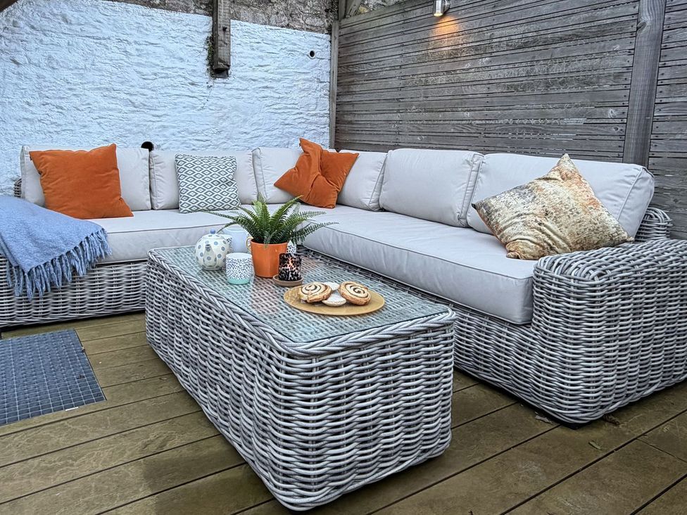 An outdoor seating area with a sofa and coffee table at Dart Views in Dartmouth