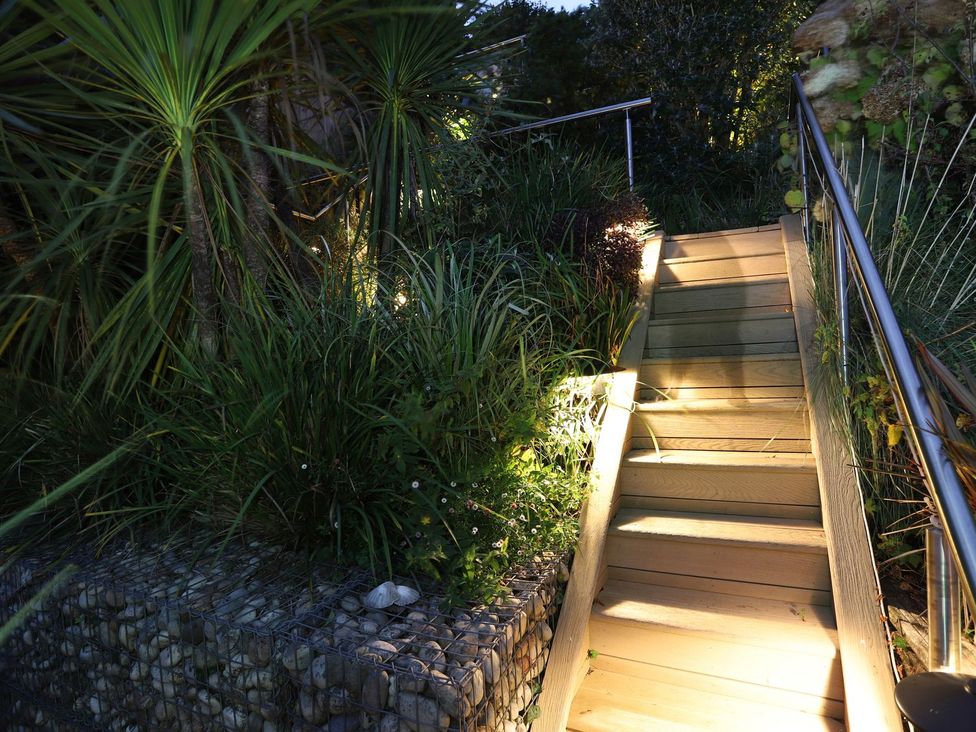 A staircase with plants and lighting at Dart Views in Dartmouth