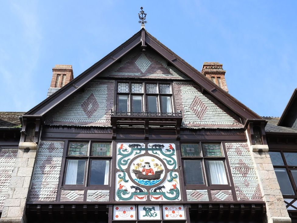 Building facade with decorative panel and windows at Dart Views in Dartmouth
