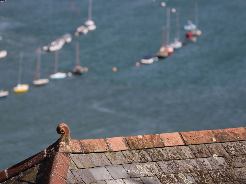 A view of boats on water with a roof in the foreground at Dart Views in Dartmouth