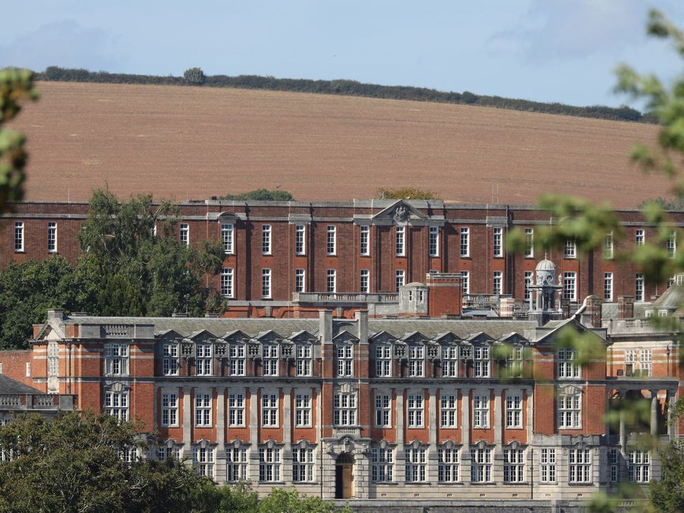 A view of a red brick building and surrounding landscape at Dart Views in Dartmouth